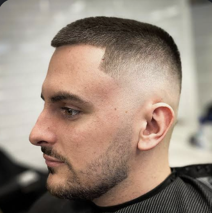 Short buzz fade with clean edge-up